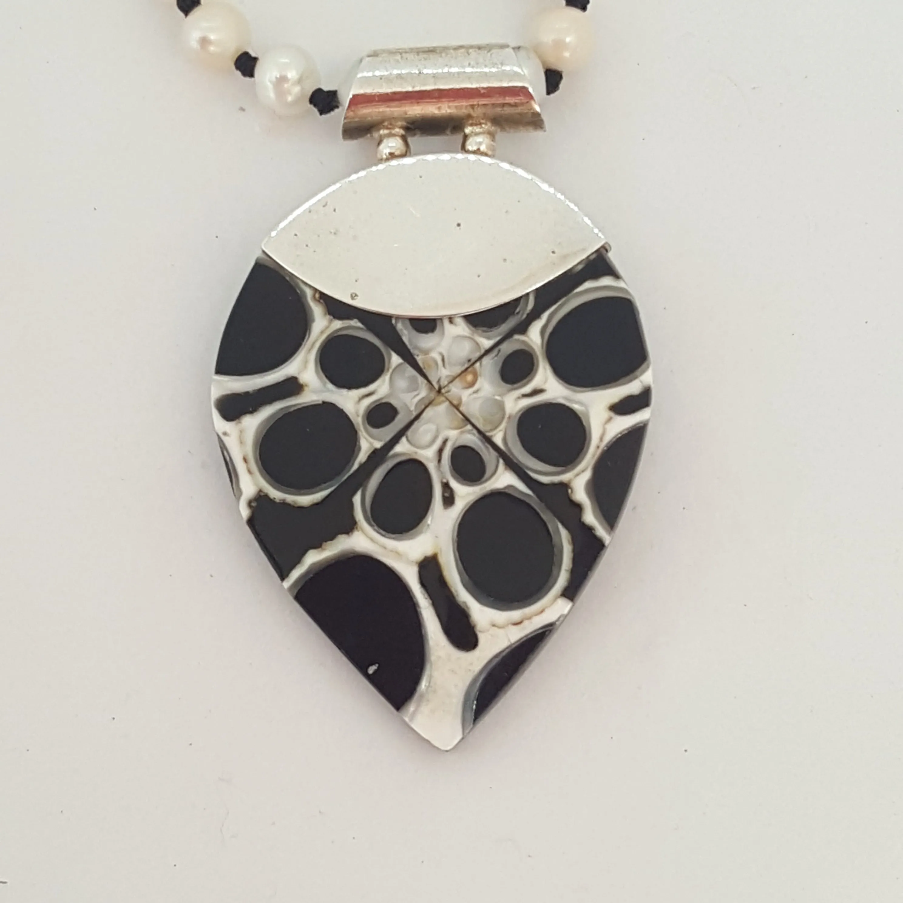 Freshwater pearls hand knotted on black with resin shell pendant